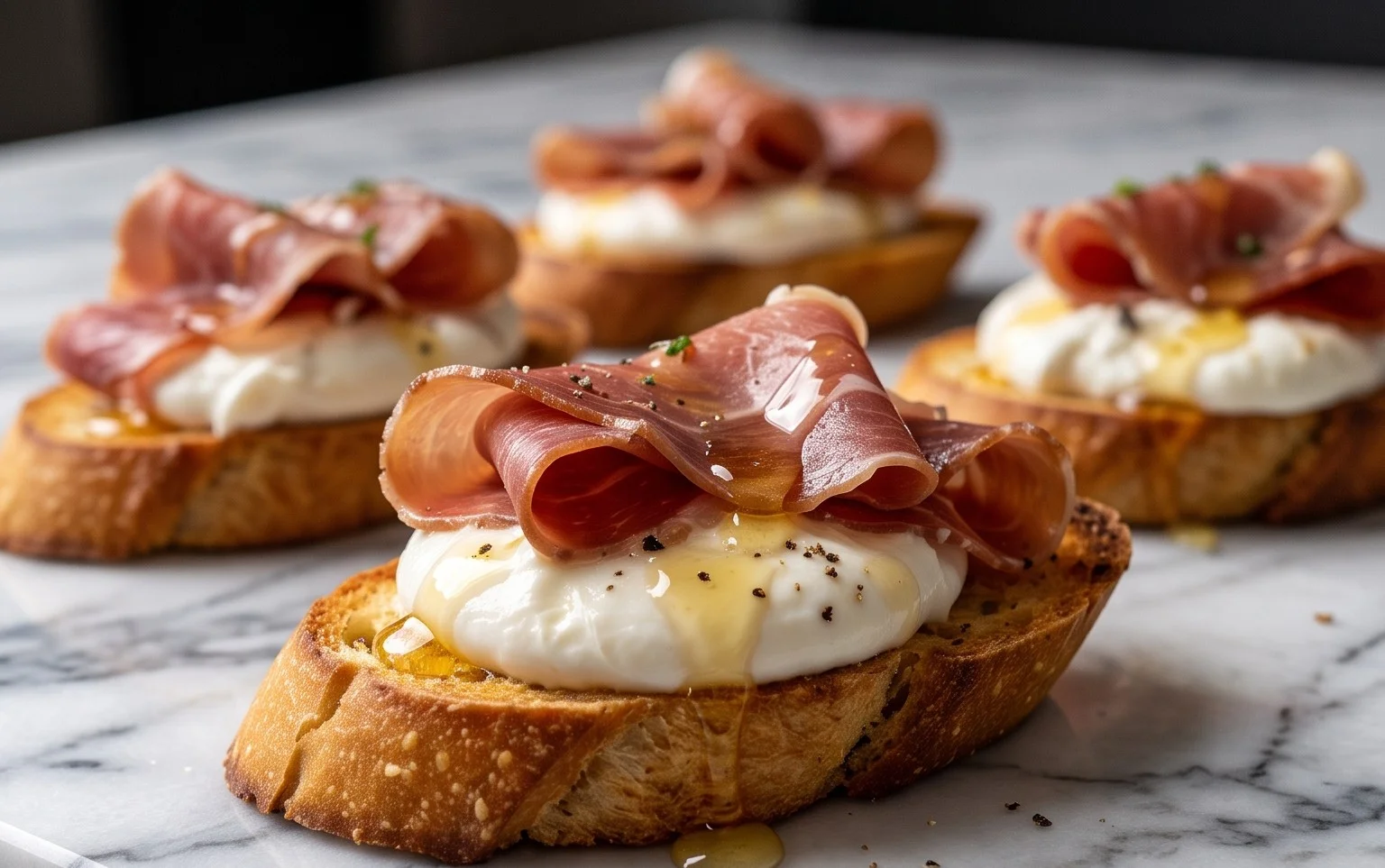 Beef Prosciutto Crostini with Burrata and Lemon Honey Drizzle